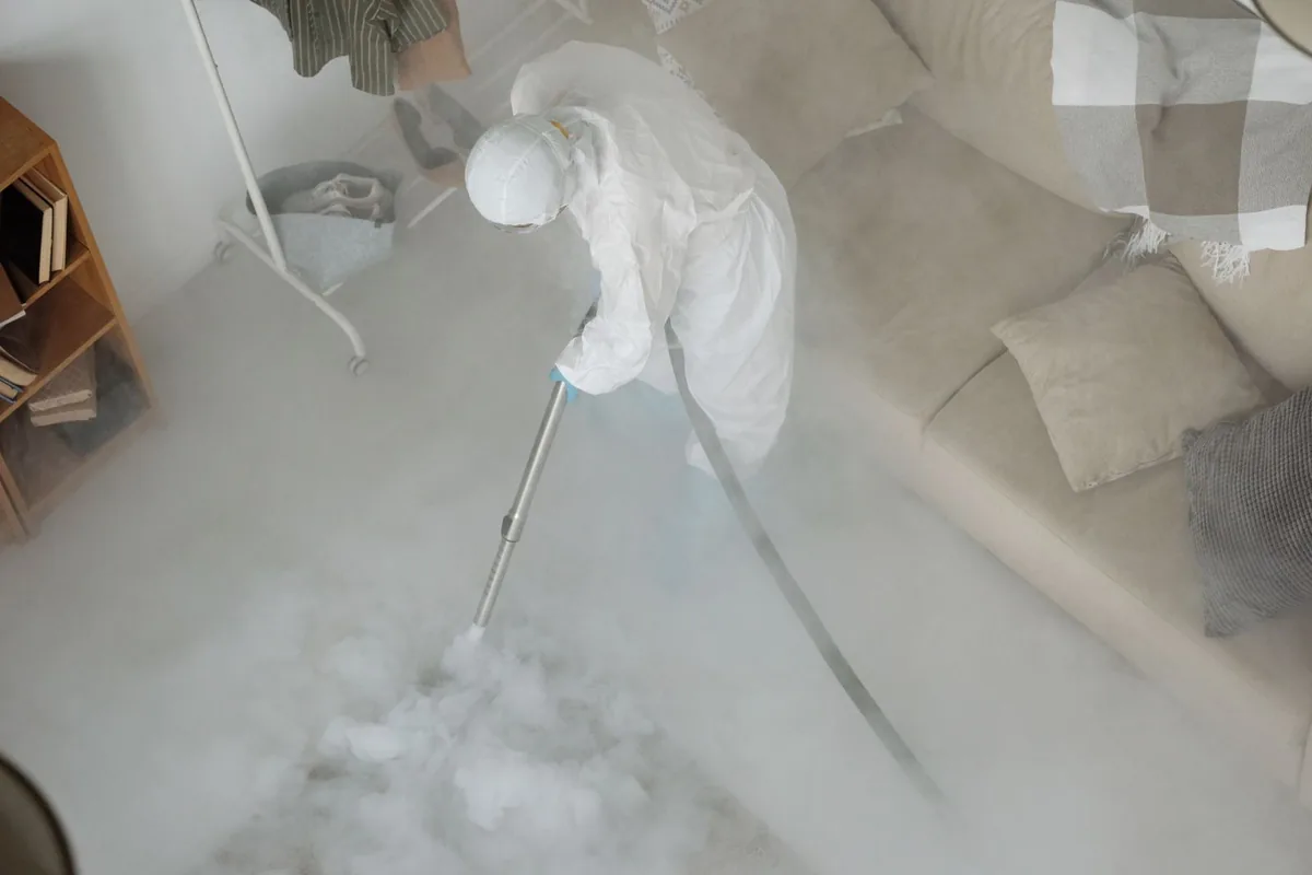Biohazard cleanup technician in protective equipment, Lake Bryan, TX